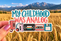 My Childhood Was Analog sticker held in hand